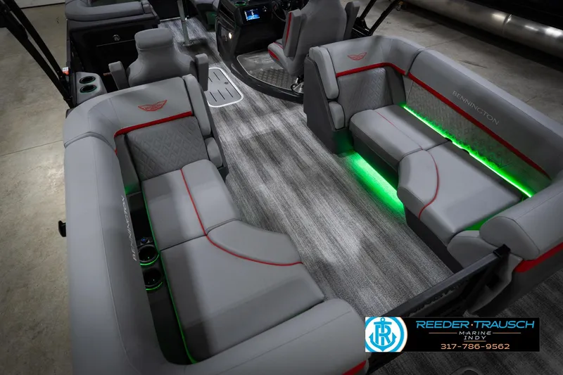 Slide: The Image of 2026 Bennington 22 MFB boat interior with gray seating, red accents, and green LED lighting. - 14
