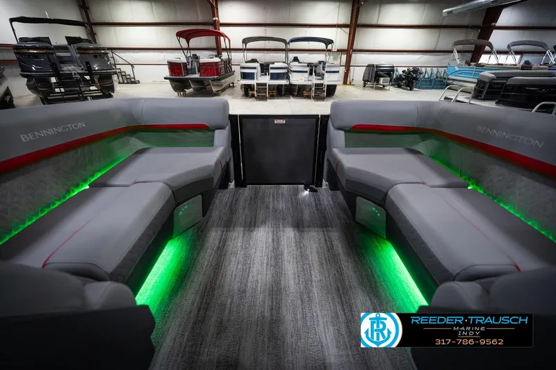 Slide: The Image of 2026 Bennington 22 MFB boat interior with gray seating and green LED lighting. - 17