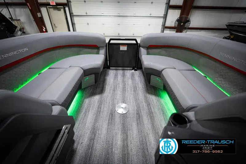 Slide: The Image of Luxurious interior of 2026 Bennington 22 MFB pontoon boat with ambient green lighting. - 21