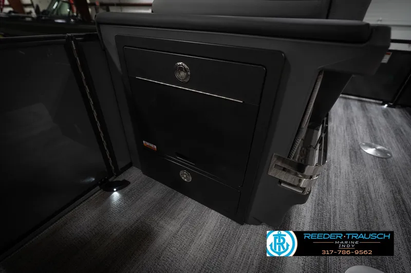 Slide: The Image of 2026 Bennington 22 MFB interior detail with storage compartment and sleek design. - 25