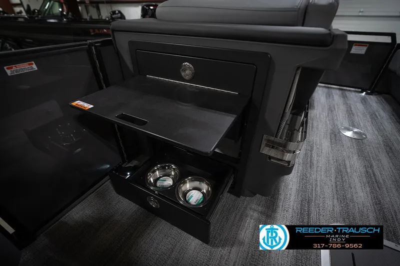 Slide: The Image of 2026 Bennington 22 MFB boat interior with storage and pet bowls. - 27