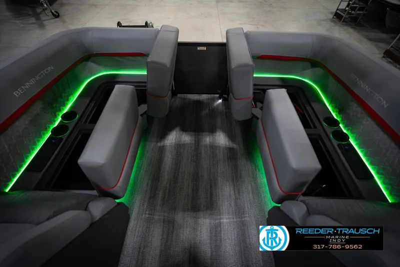Slide: The Image of 2026 Bennington 22 MFB boat interior with green LED lighting and gray seating. - 29