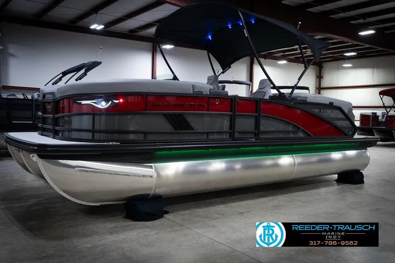 Slide: The Image of 2026 Bennington 22 MFB pontoon boat in showroom with canopy and LED lights. - 3