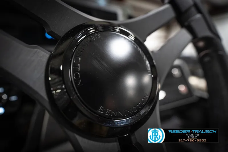 Slide: The Image of Close-up of 2026 Bennington 22 MFB steering wheel with logo, Reeder-Trausch Marine branding. - 32