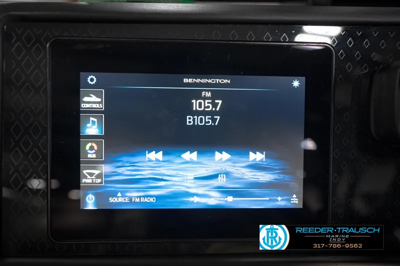 Slide: The Image of Touchscreen display in a 2026 Bennington 22 MFB showing FM radio controls and station 105.7. - 33