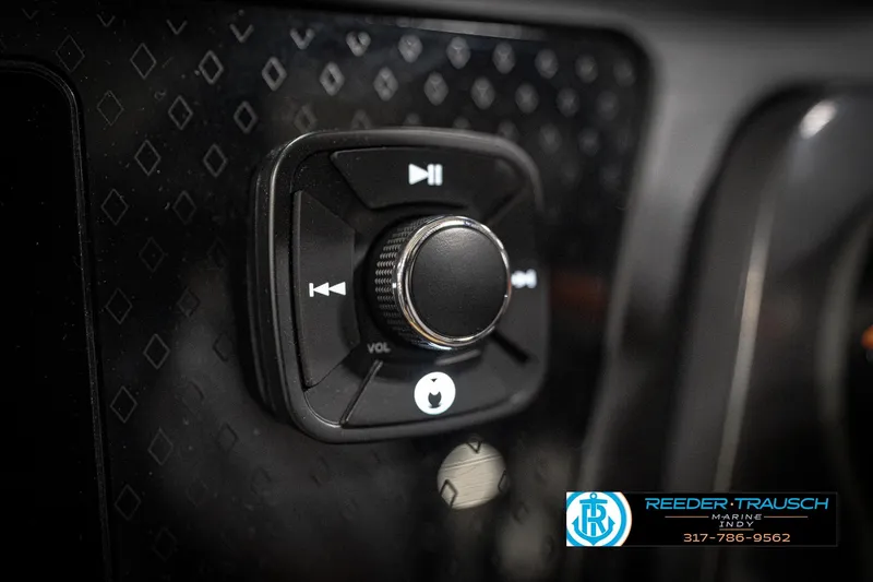 Slide: The Image of Close-up of 2026 Bennington 22 MFB audio control knob with Reeder-Trausch Marine logo. - 34
