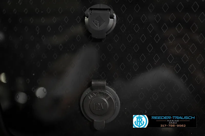 Slide: The Image of 12V marine outlet on 2026 Bennington 22 MFB boat dashboard with diamond pattern. - 36