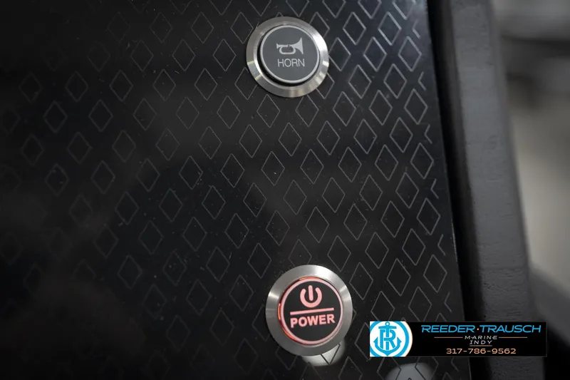 Slide: The Image of Close-up of 2026 Bennington 22 MFB control panel with horn and power buttons. - 37