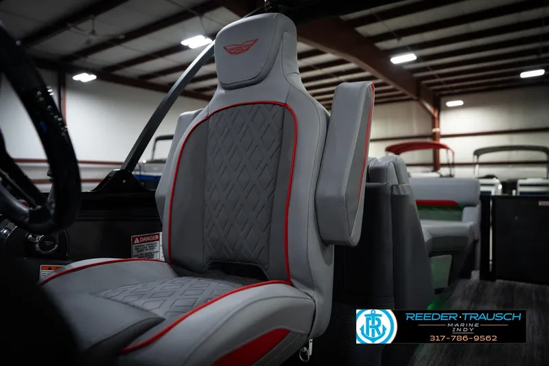 Slide: The Image of 2026 Bennington 22 MFB boat interior with gray and red seating in showroom. - 39