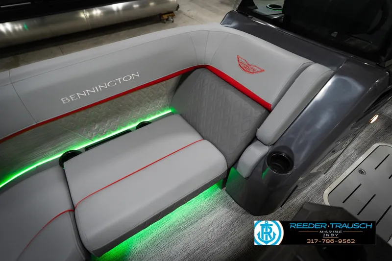 Slide: The Image of 2026 Bennington 22 MFB boat interior with gray seating, red accents, and green LED lighting. - 43
