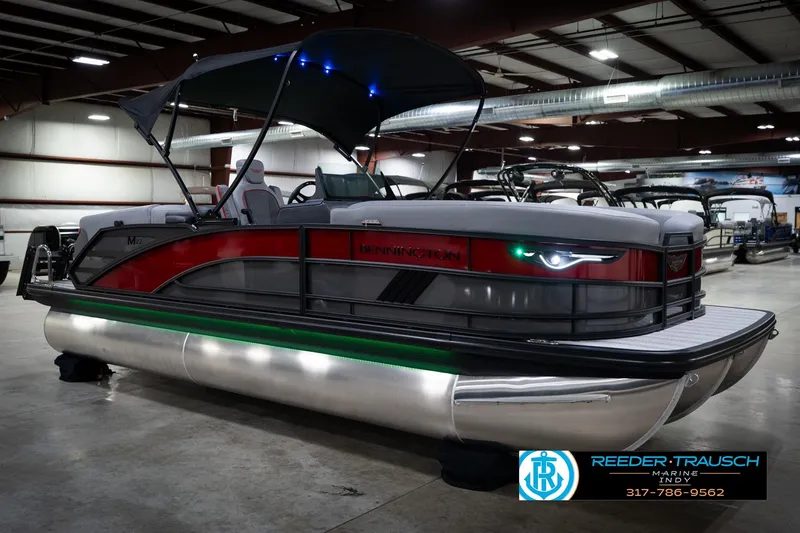 Slide: The Image of 2026 Bennington 22 MFB pontoon boat in showroom with canopy and LED lights. - 5