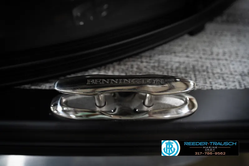 Slide: The Image of 2026 Bennington 22 MFB boat cleat with engraved logo, showcased by Reeder-Trausch Marine. - 56