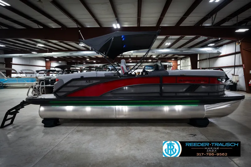 Slide: The Image of 2026 Bennington 22 MFB pontoon boat in showroom, featuring sleek design and modern amenities. - 6