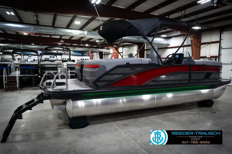 Slide: The Image of 2026 Bennington 22 MFB pontoon boat in showroom, featuring sleek design and modern amenities. - 7