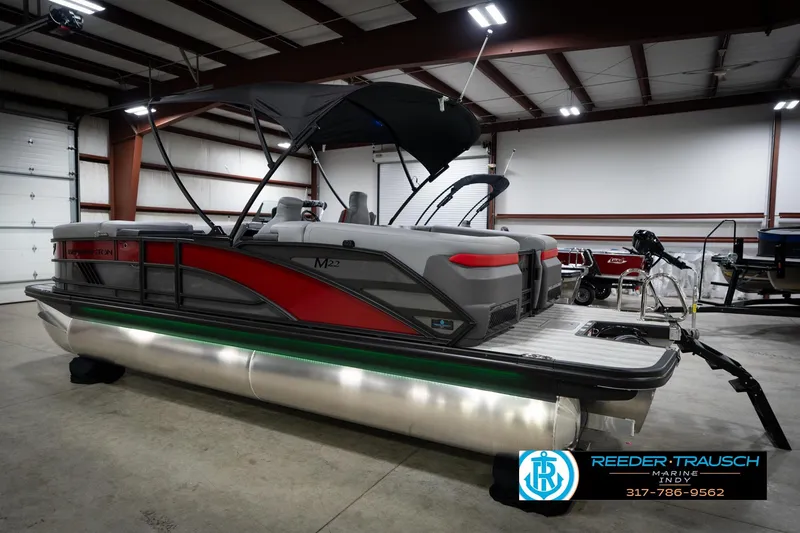 Slide: The Image of 2026 Bennington 22 MFB pontoon boat in a showroom, featuring sleek design and modern amenities. - 9