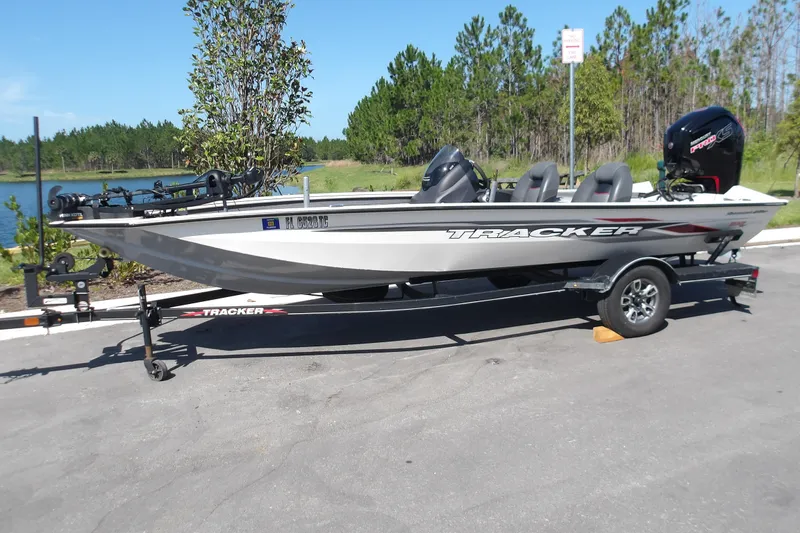 Slide: The Image of 2022 Tracker Pro Team 190 TX Tournament Edition boat on trailer by a lake. - 11