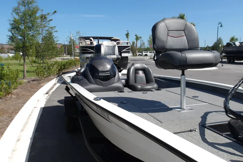 Slide: The Image of 2022 Tracker Pro Team 190 TX Tournament Edition boat with seating, parked outdoors. - 6