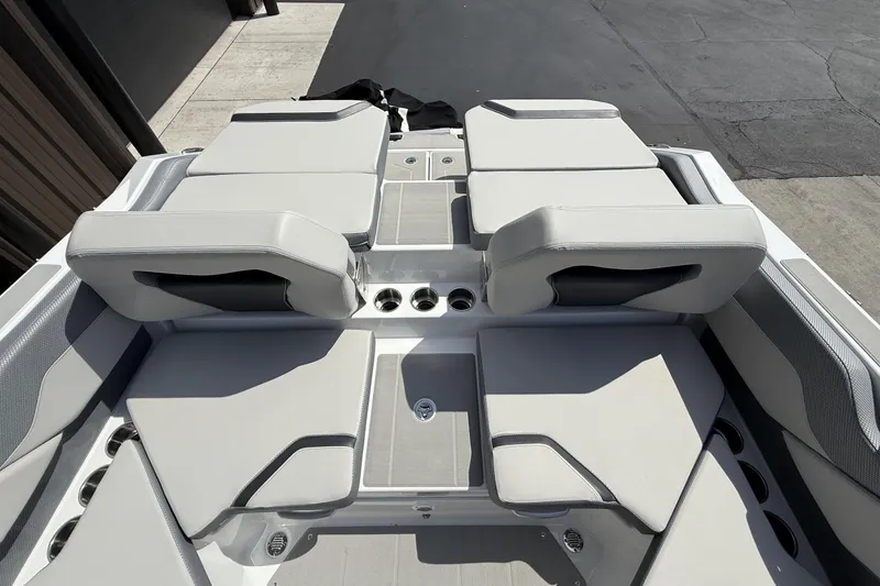 Slide: The Image of 2026 Scarab 235 SE boat interior with sleek, modern seating and cup holders. - 11
