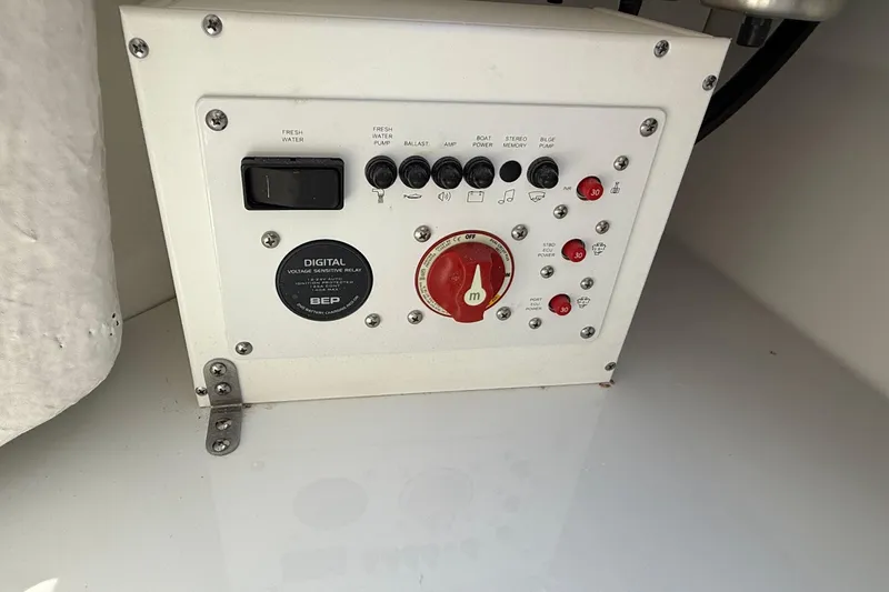 Slide: The Image of Control panel of 2026 Scarab 235 SE boat with switches and dials. - 17