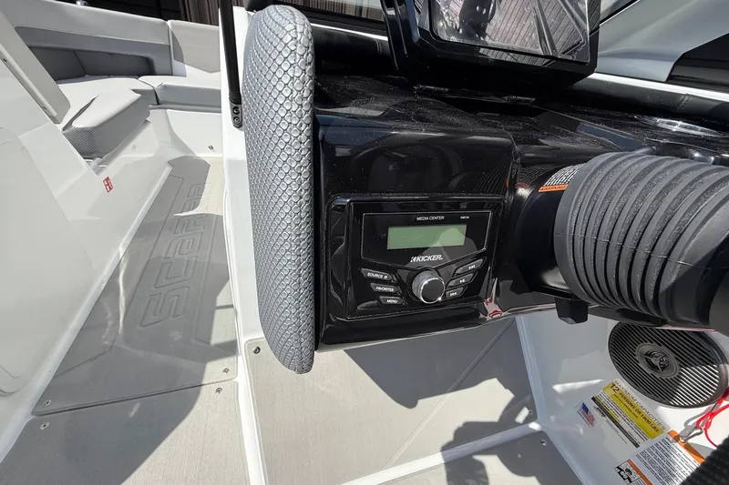 Slide: The Image of 2026 Scarab 235 SE boat interior with Kicker media center and seating area. - 21