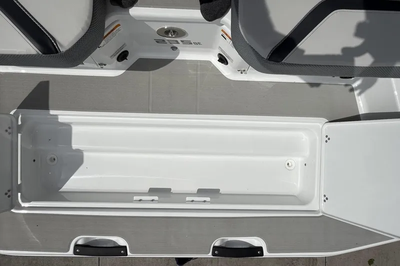 Slide: The Image of 2026 Scarab 235 SE boat interior storage compartment with open hatch. - 22