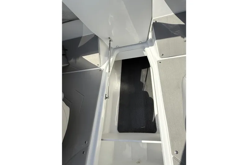 Slide: The Image of Interior view of 2026 Scarab 235 SE boat, showcasing storage compartment and seating area. - 24