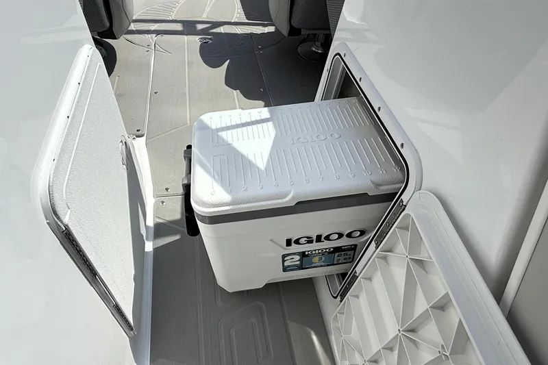 Slide: The Image of Igloo cooler stored in 2026 Scarab 235 SE boat compartment. - 25