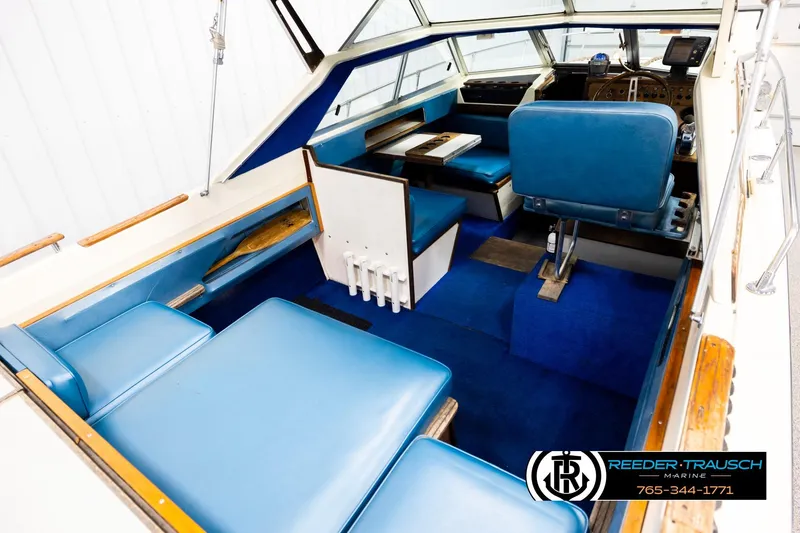 Slide: The Image of 1977 Searay 220 OV boat interior with blue seating and wooden accents. - 11