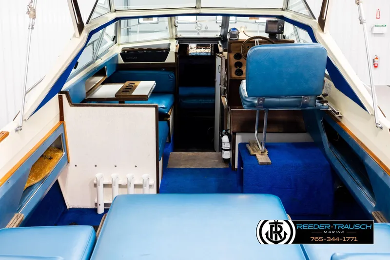 Slide: The Image of 1977 Searay 220 OV boat interior with blue seating and dashboard, Reeder-Trausch Marine logo. - 12