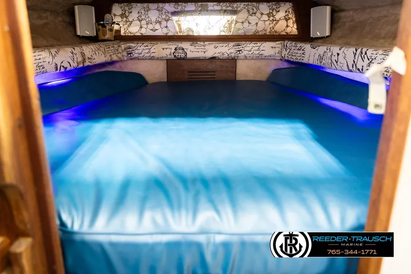 Slide: The Image of 1977 Searay 220 OV cabin interior with blue lighting and patterned walls. - 14