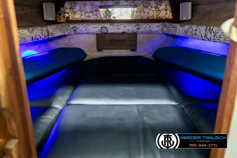 Slide: The Image of 1977 Searay 220 OV cabin interior with blue LED lighting and comfortable seating. - 15