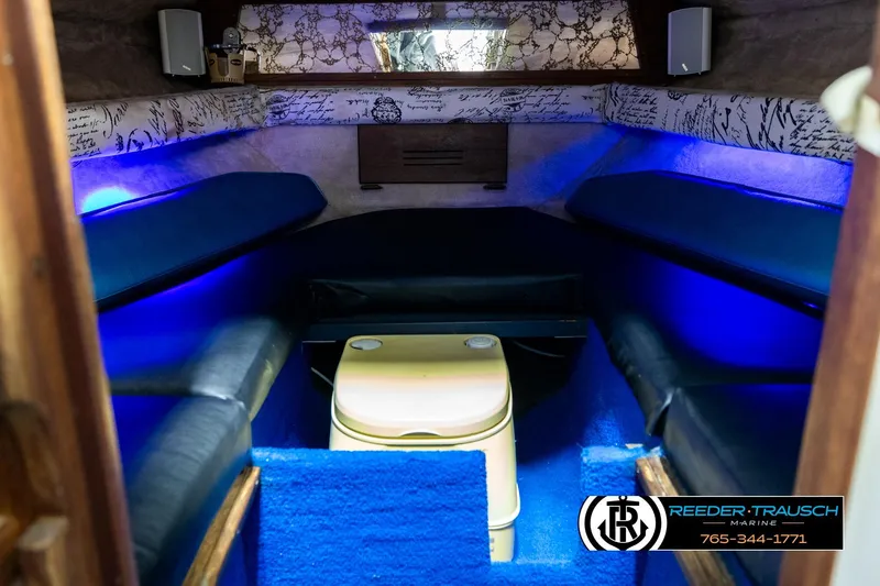 Slide: The Image of Interior of a 1977 Searay 220 OV boat with blue lighting and seating. - 16