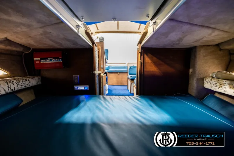 Slide: The Image of Interior of 1977 Searay 220 OV boat with blue seating and wood accents. - 17
