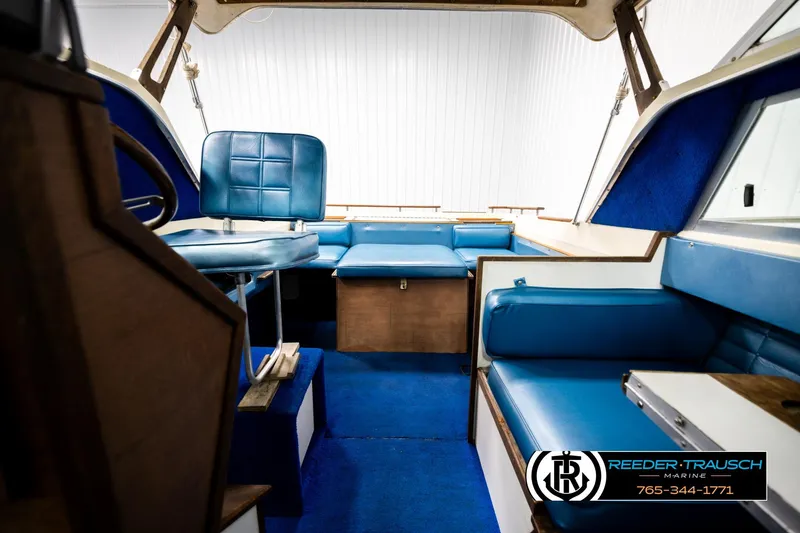 Slide: The Image of Interior of a 1977 Searay 220 OV boat with blue seating and wood accents. - 18