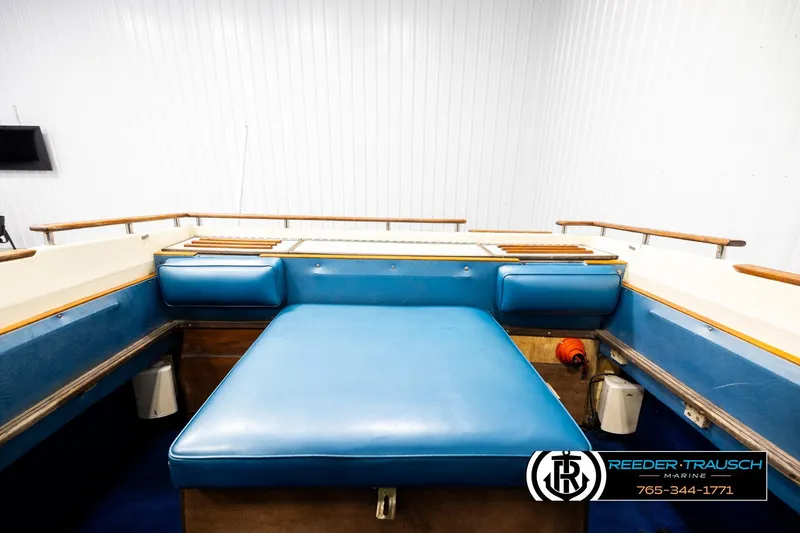 Slide: The Image of 1977 Searay 220 OV boat interior with blue seating and wooden accents. - 20