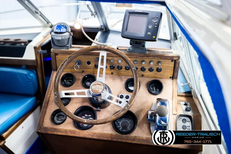 Slide: The Image of 1977 Searay 220 OV boat dashboard with steering wheel and navigation instruments. - 30