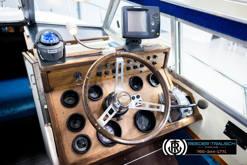 Slide: The Image of 1977 Searay 220 OV boat dashboard with steering wheel and navigation instruments. - 31