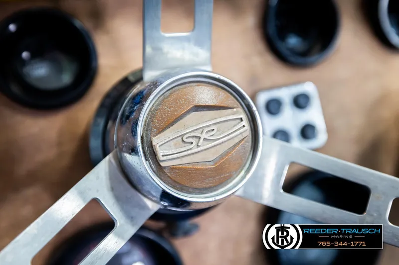 Slide: The Image of Close-up of a 1977 Searay 220 OV steering wheel with logo and marine branding. - 32