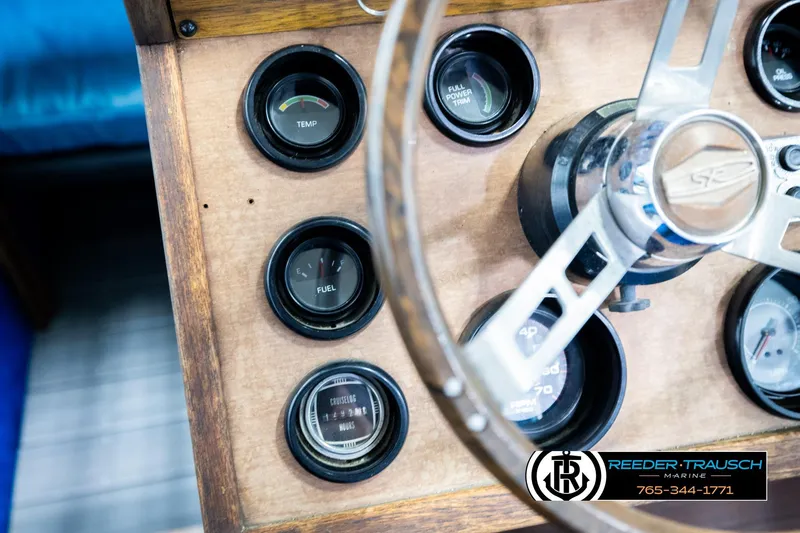 Slide: The Image of 1977 Searay 220 OV dashboard with gauges and steering wheel, Reeder-Trausch Marine branding. - 33