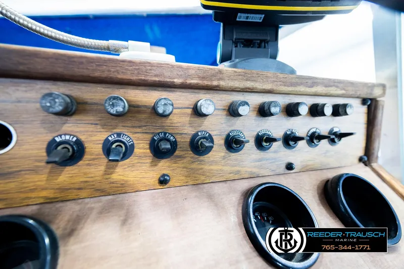 Slide: The Image of 1977 Searay 220 OV boat dashboard with switches and gauges, featuring Reeder-Trausch Marine branding. - 38