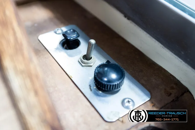 Slide: The Image of Control panel of a 1977 Searay 220 OV boat with toggle and rotary switches. - 42