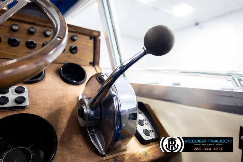 Slide: The Image of 1977 Searay 220 OV boat dashboard with steering wheel and throttle controls. - 44