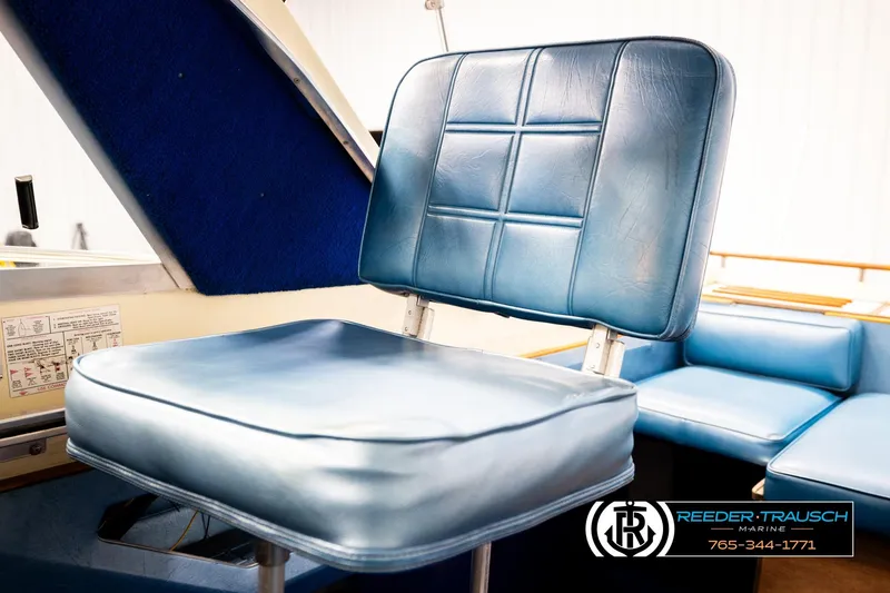 Slide: The Image of 1977 Searay 220 OV boat interior with blue cushioned seating. - 45