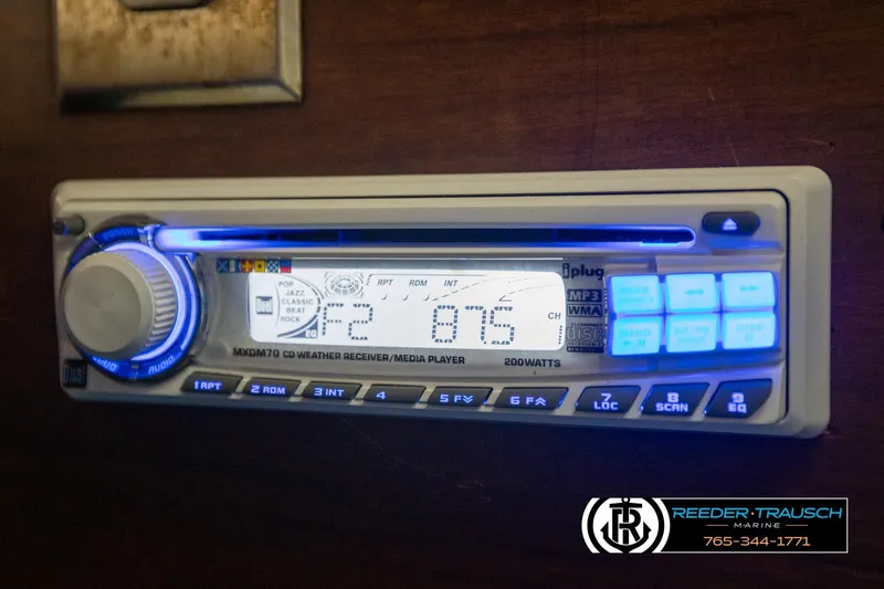 Slide: The Image of 1977 Searay 220 OV boat stereo system with illuminated controls and digital display. - 47