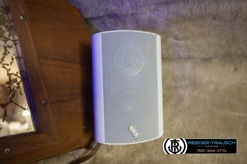 Slide: The Image of White speaker mounted on a wooden surface inside a 1977 Searay 220 OV boat. - 48