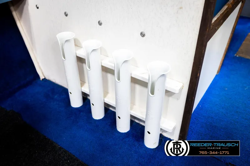 Slide: The Image of White rod holders on a 1977 Searay 220 OV boat, blue carpet, Reeder-Trausch Marine logo. - 49