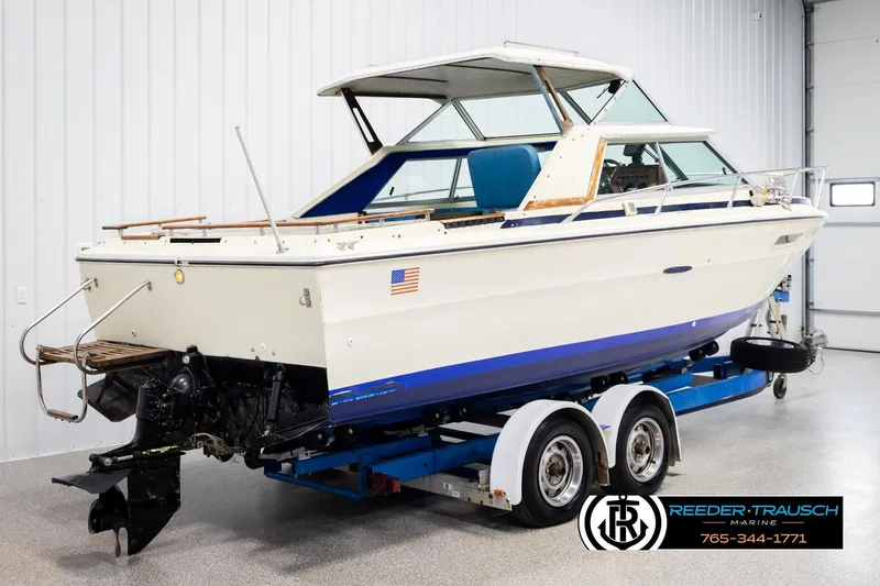 Slide: The Image of 1977 Searay 220 OV boat on trailer in indoor storage facility. - 5