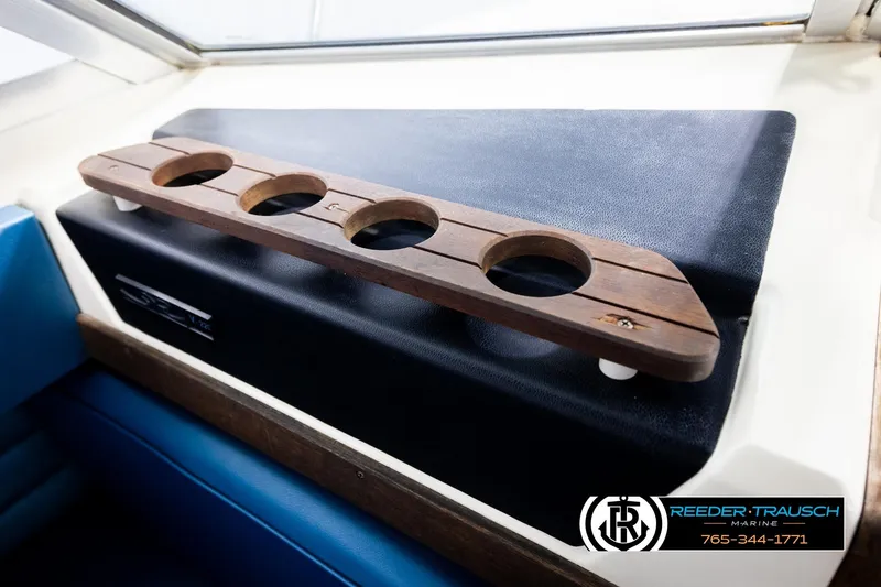 Slide: The Image of 1977 Searay 220 OV boat interior with wooden cup holder and blue seating. - 51