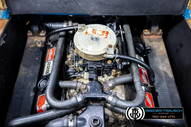 Slide: The Image of 1977 Searay 220 OV engine compartment with visible hoses and components. - 53