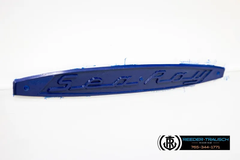 Slide: The Image of Blue "Sea Ray" emblem on a 1977 Searay 220 OV boat. - 60